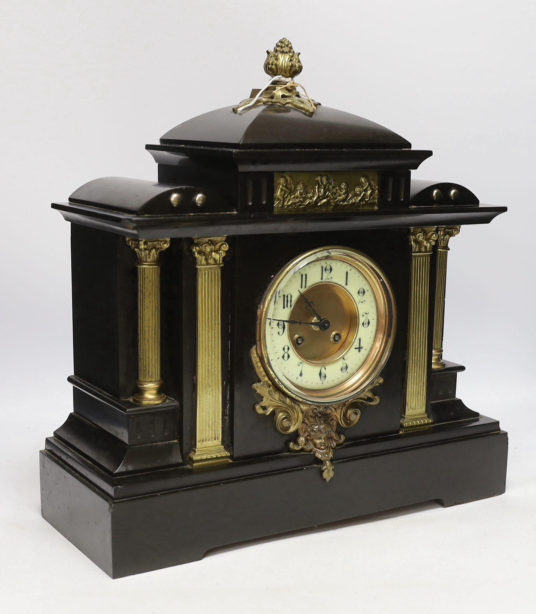 A black slate mantel clock with gilded pillars, striking on a coiled gong, 41cm high